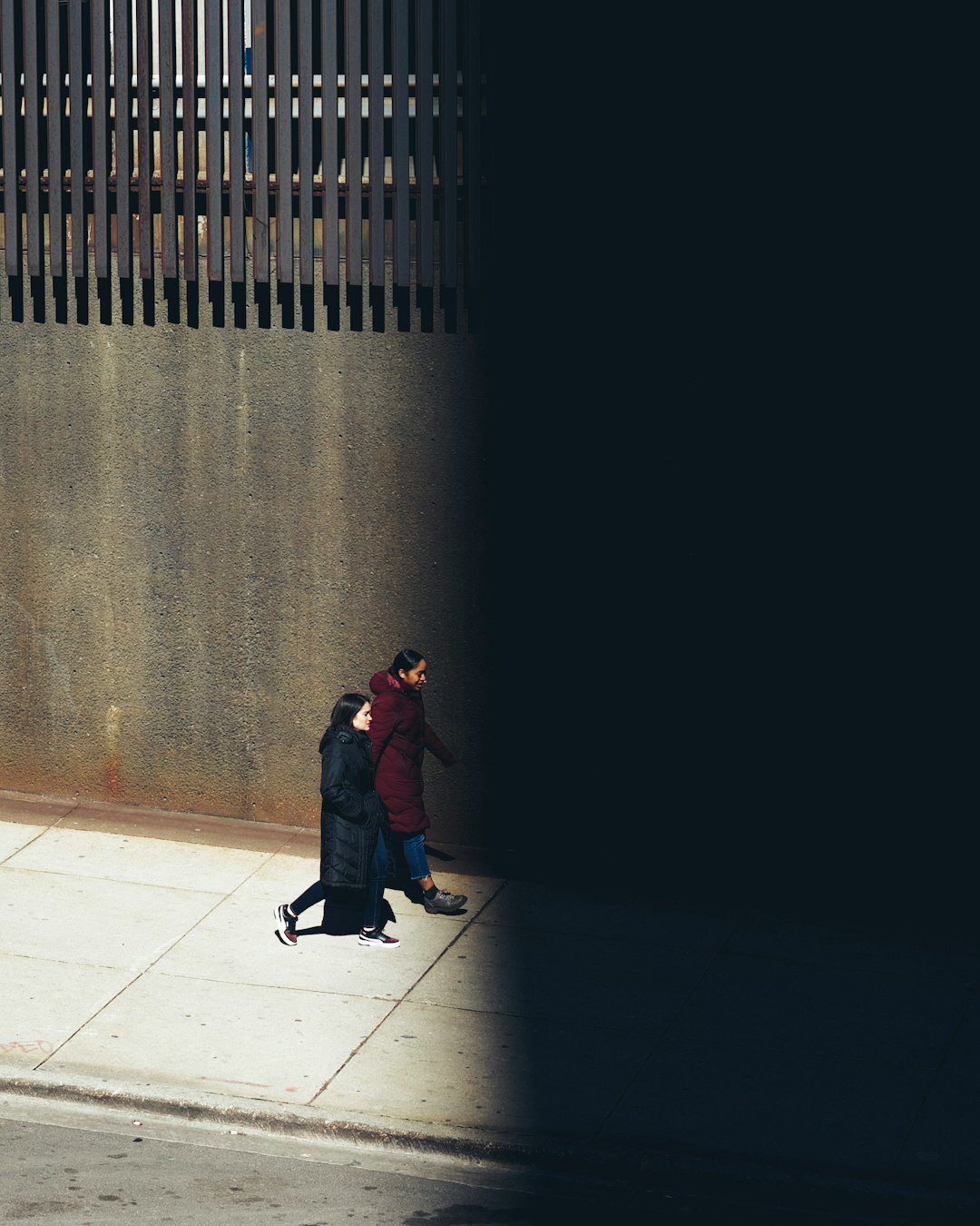 two people talking in shadows