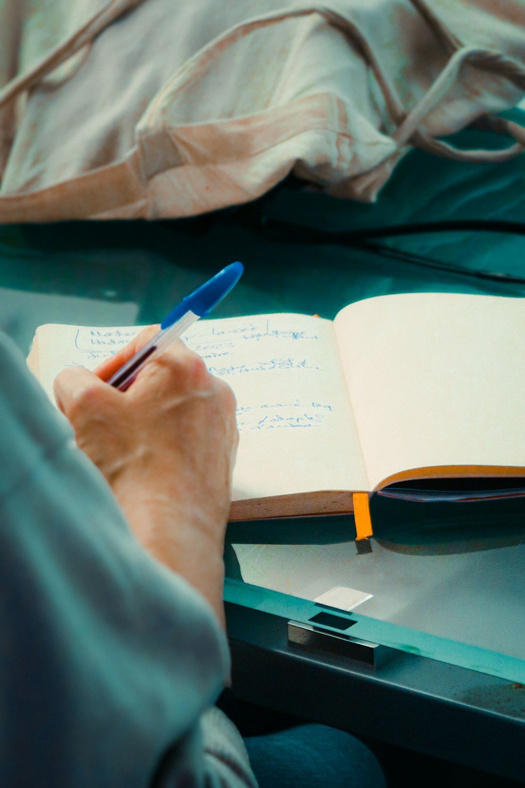 person writing notebook